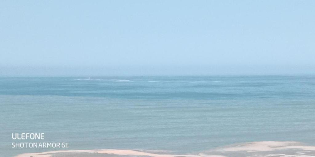 a view of the ocean from a beach at La Belle Vue in Lima