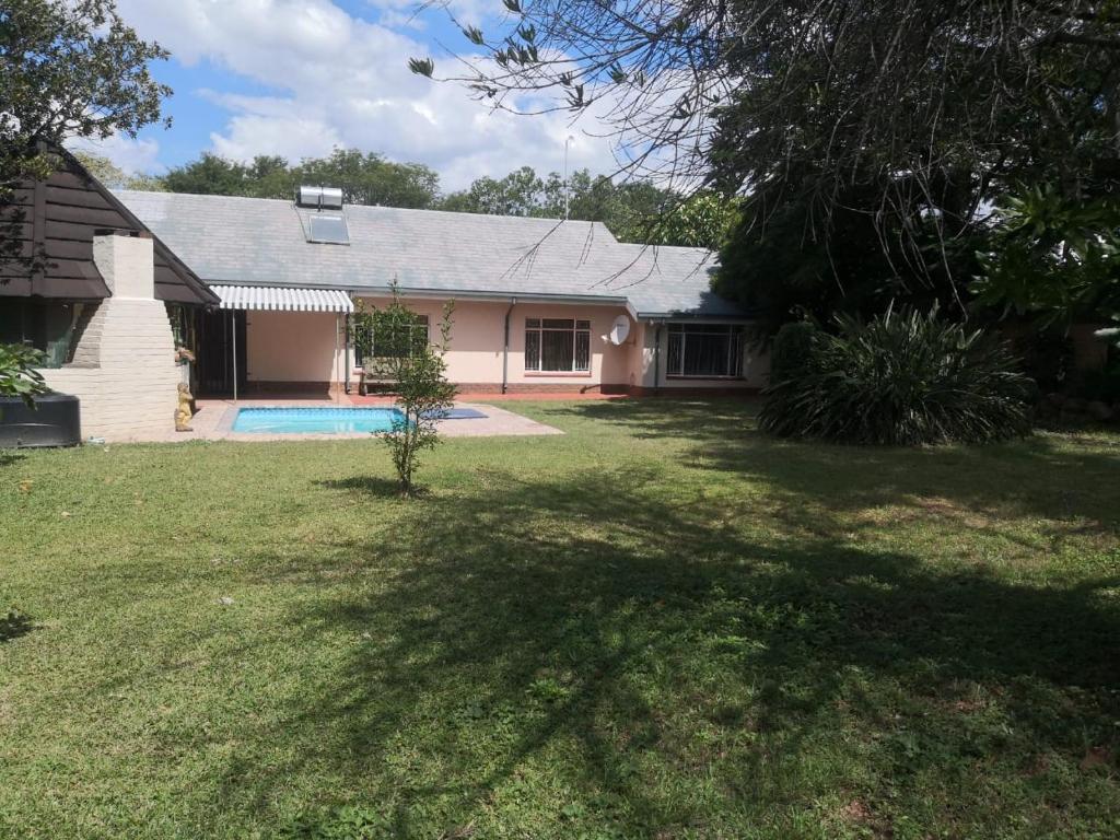 a house with a swimming pool in a yard at 15 On Reitz Bela bela in Bela-Bela