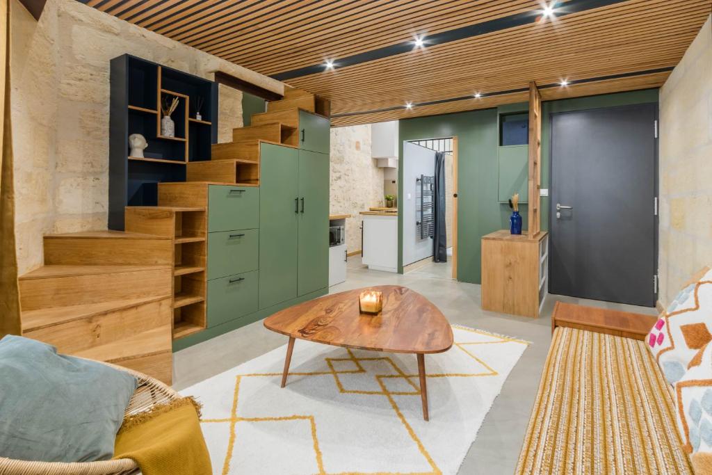 un salon avec une table et un escalier dans l'établissement LA Sainte Catherine 264, à Bordeaux