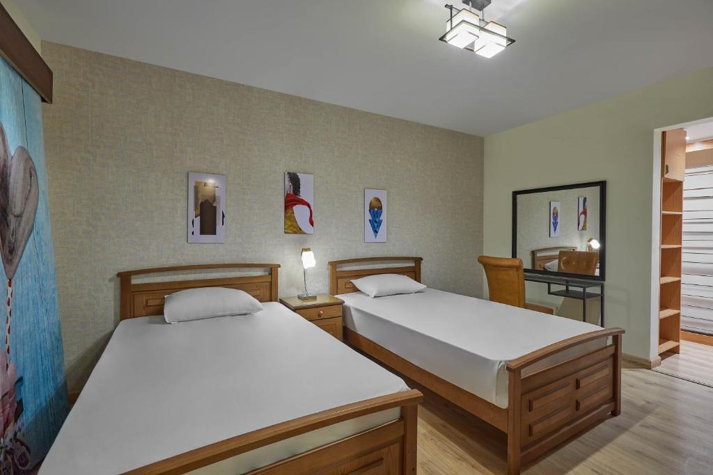 Postel nebo postele na pokoji v ubytování Golden Park Hotel Cairo, Heliopolis