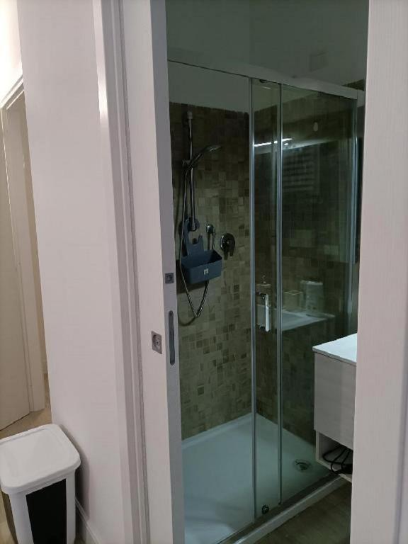 a glass shower in a bathroom with a toilet at Riviera Albachiara Anzio B&B in Anzio