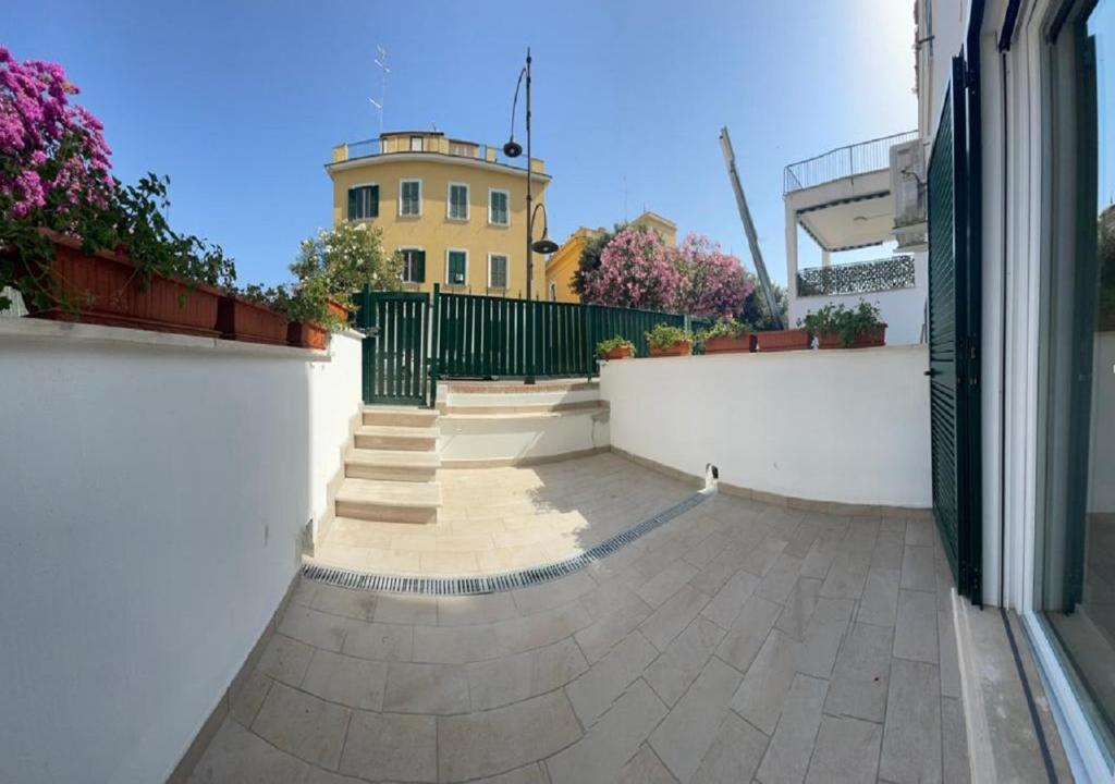 a courtyard with a building in the background at Riviera Albachiara Anzio B&B in Anzio