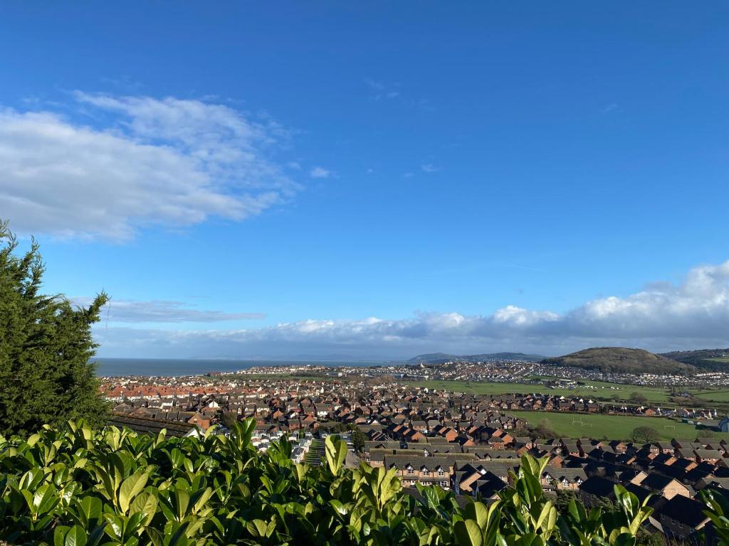 a view of a city from a hill at Llandudno Boutique style seaside retreat with stunning views in Llandrillo-yn-Rhôs