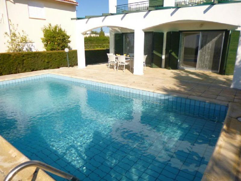 a swimming pool in front of a house at Villa Magnolia in Coral Bay