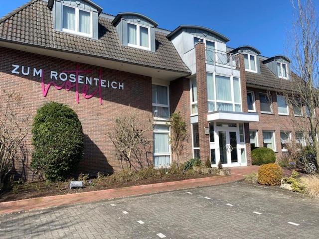 a brick building with a sign that reads run research at Hotel zum Rosenteich in Bad Zwischenahn