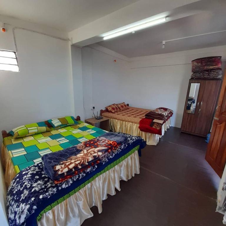 Postel nebo postele na pokoji v ubytování Jasmine Homestay Darjeeling
