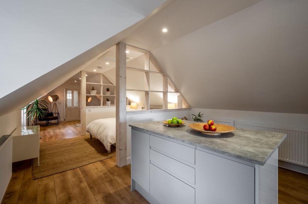 a kitchen with a counter with a bowl of fruit on it at Modern and Stylish WoodHous in Forfar