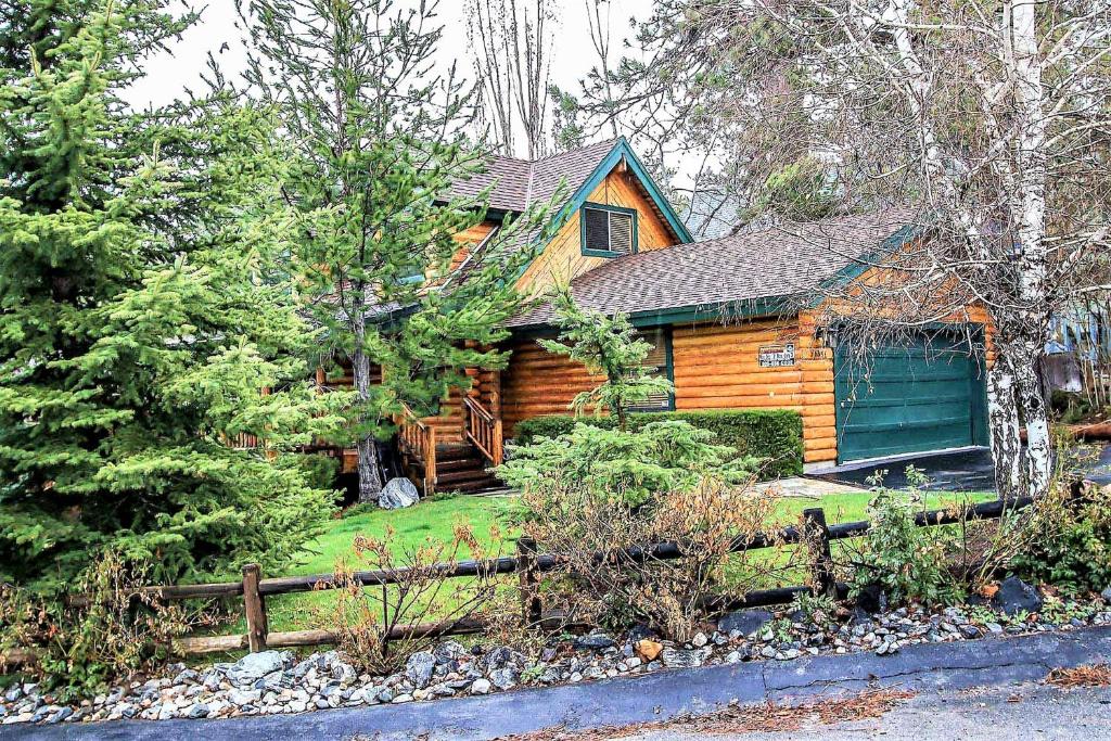 a log cabin with a fence in front of it at Knotty and Nice-177 by Big Bear Vacations in Big Bear Lake