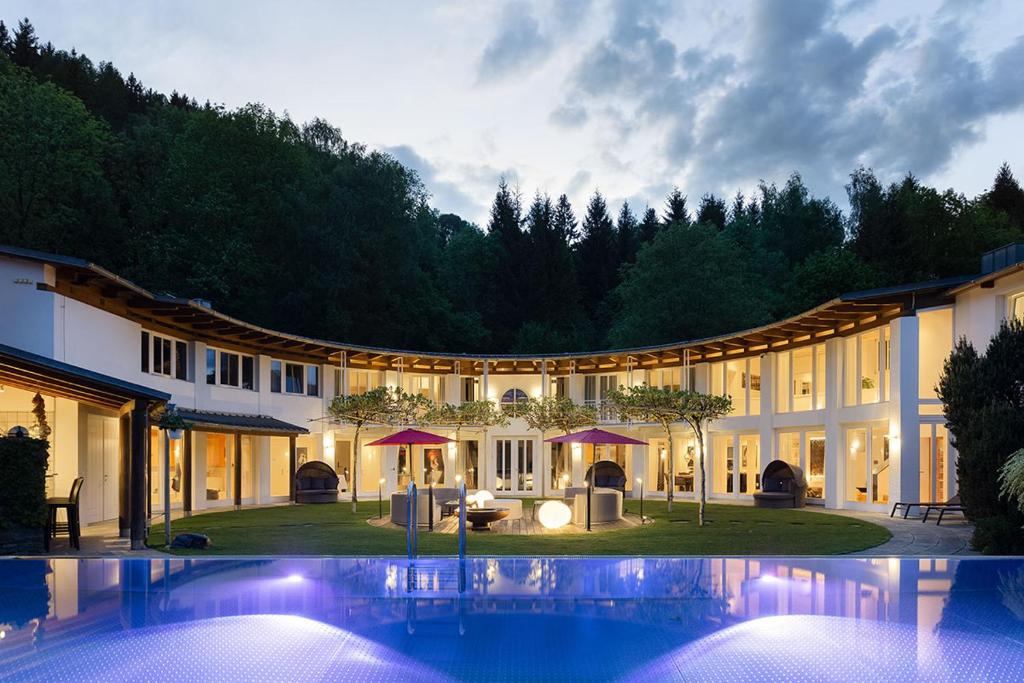 a large house with a swimming pool in front of it at Designferienhaus Privat Villa+ Pool+ Park+ Sport in Micheldorf