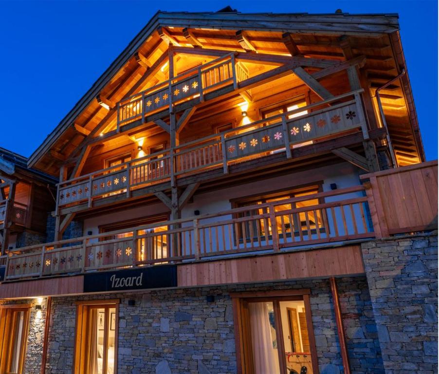 a large building with balconies on top of it at Chalet Izoard in Saint-Chaffrey