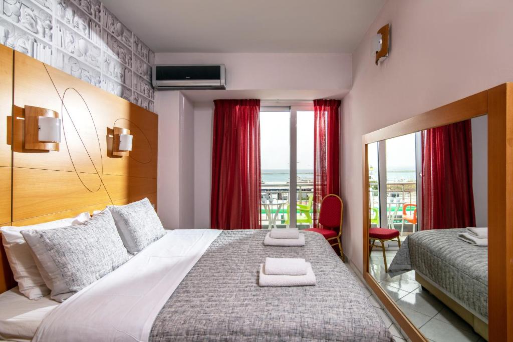 a bedroom with a large bed and a window at Life Hotel by Estia in Heraklio
