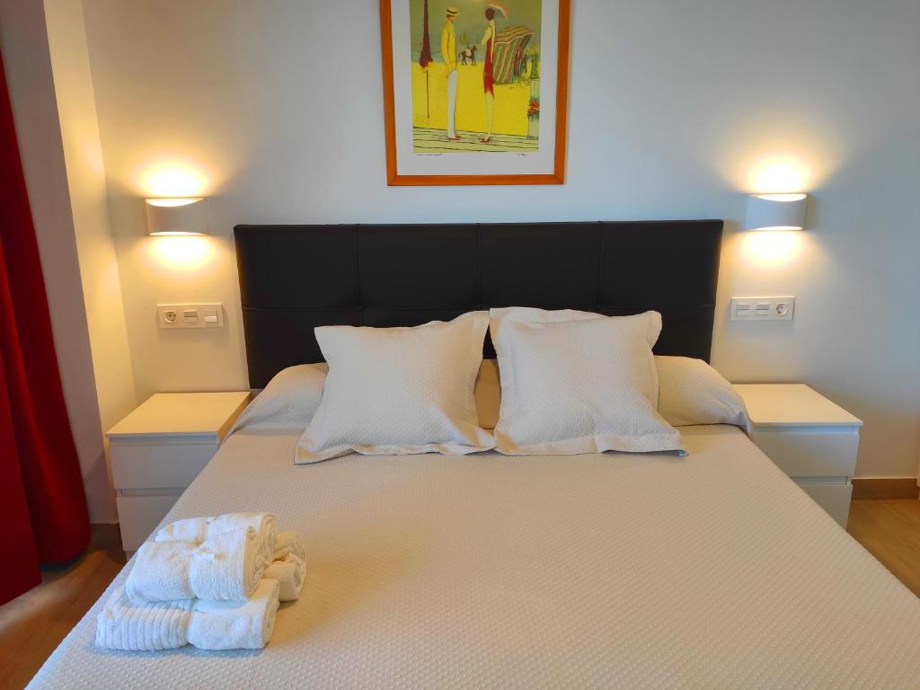 A bed or beds in a room at BEACHFRONT -- NEW LUXURY Apartment -- 1ª Linea Playa -- Fuengirola CITY CENTER -- Private PARKING -- Panoramic Sea Views --