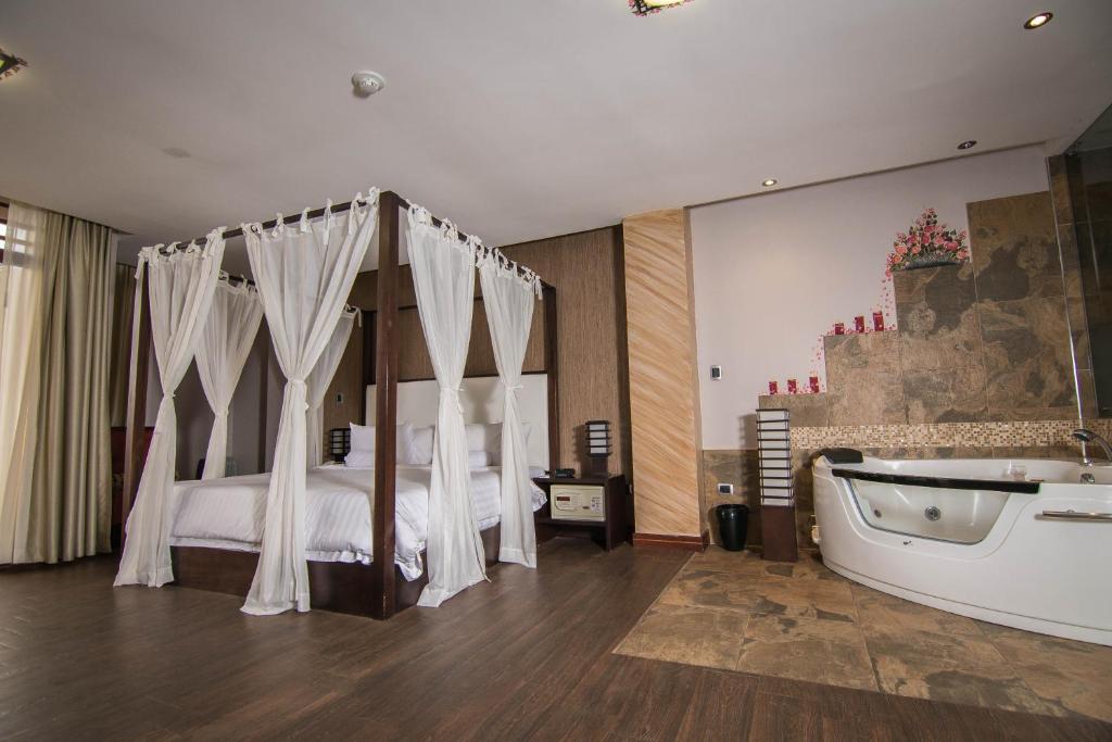 Postel nebo postele na pokoji v ubytování Arhaná Hosteria & Resort