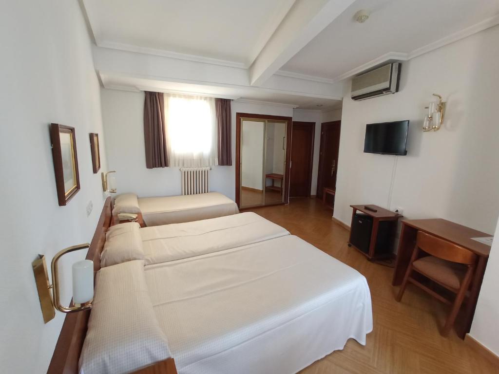 Postel nebo postele na pokoji v ubytování Hotel ELE Acueducto