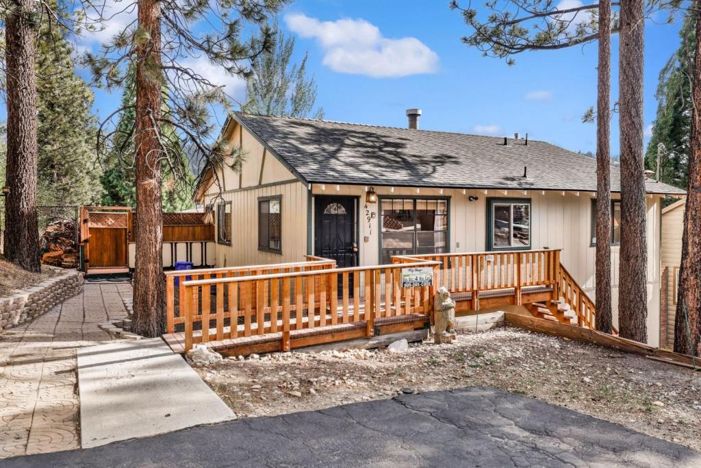 a house with a wooden fence and a porch at Happy Bear #2053 by Big Bear Vacations in Big Bear Lake