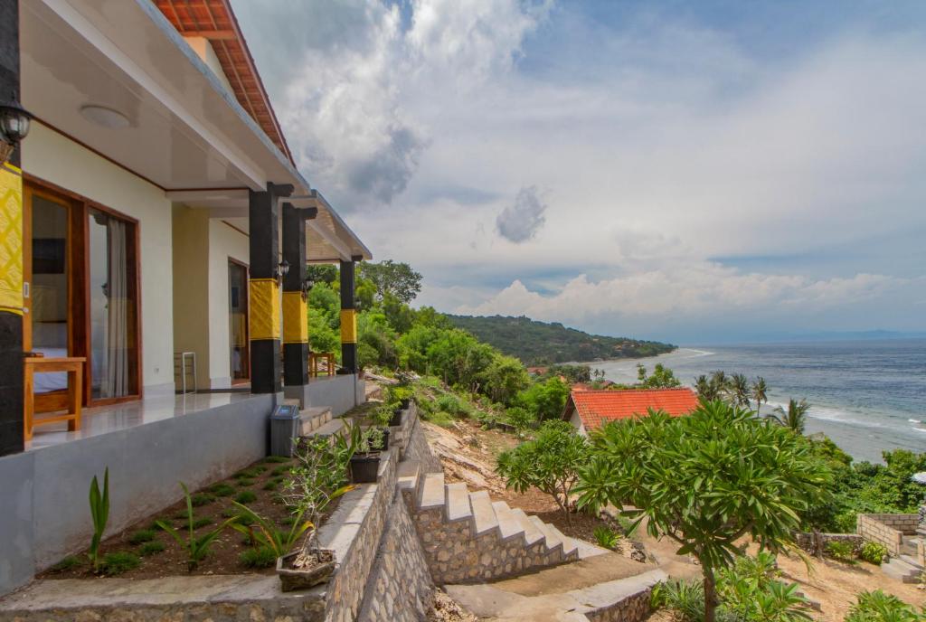 a house with a view of the ocean at Goa Giri Hill Bungalow in Nusa Penida