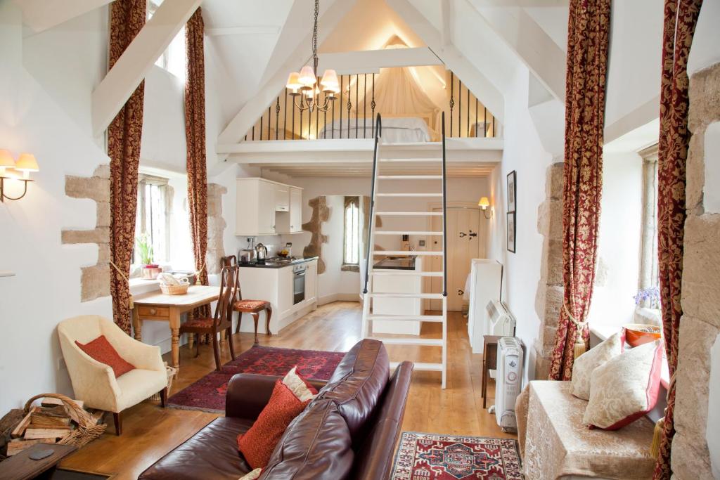a living room with a couch and a table at Welsh Gatehouse A Historic Castle Retreat that Welcomes Dogs and Electric Vehicles in Mathern