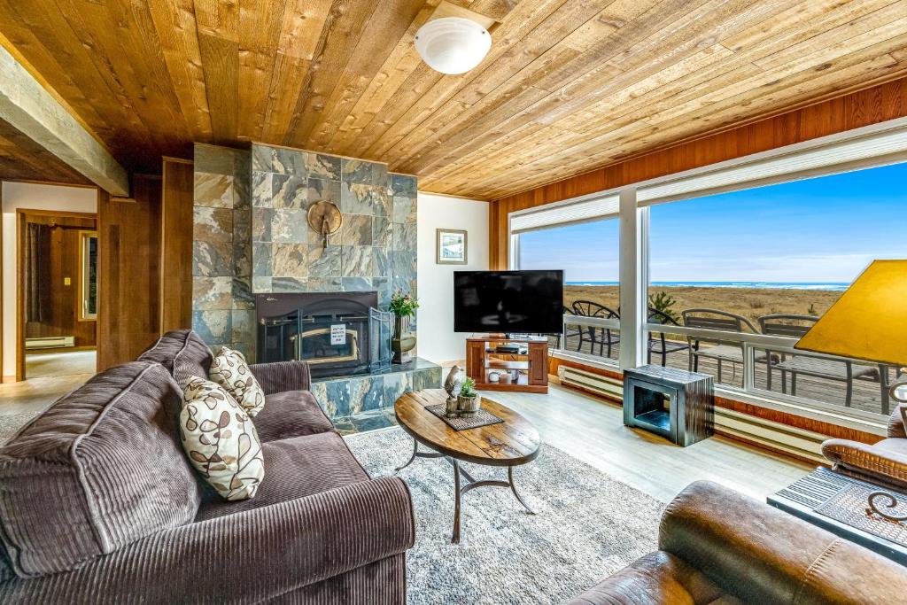 a living room with a couch and a fireplace at Captain's Quarters in Seaside