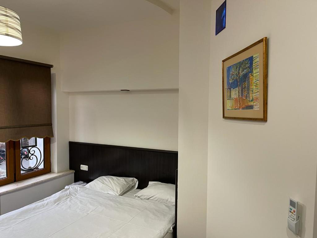 a bedroom with a bed and a picture on the wall at Yerevan Hostel in Yerevan