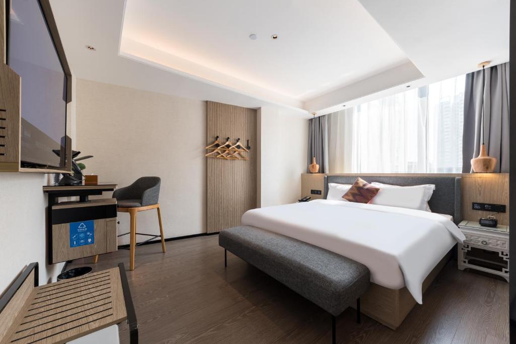 Postel nebo postele na pokoji v ubytování Paco Hotel Canton Tower Pazhou