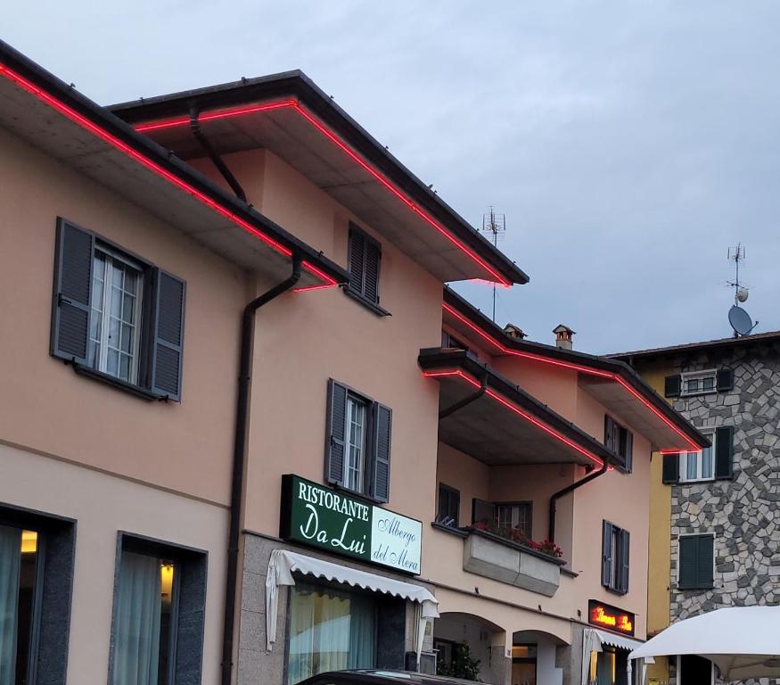 a building with a sign on the side of it at Albergo del mera-ristorante da Lui in Sorico