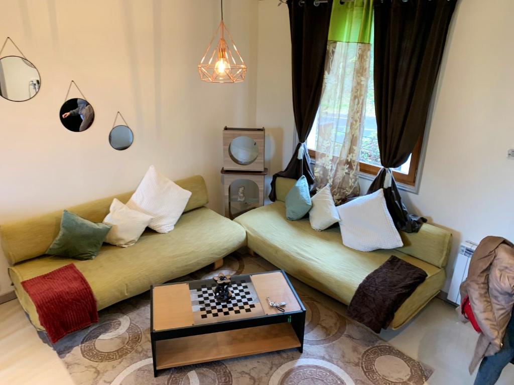 - un salon avec deux canapés et un échiquier dans l'établissement Maison spacieuse avec jardin à Saint-Brice-sous-Forêt, à Saint-Brice-sous-Forêt