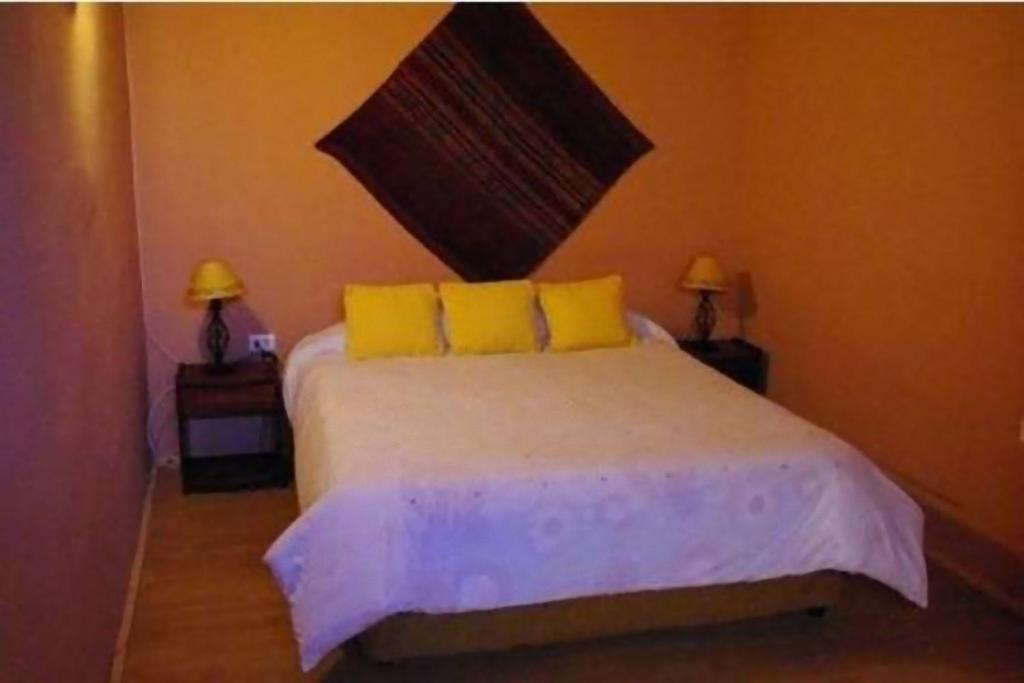 Postel nebo postele na pokoji v ubytování Hostal Nuevo Amanecer