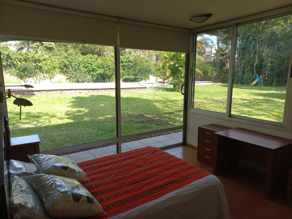 a bedroom with a bed and a large window at Parana Riverside Guest House - Posadas in Posadas