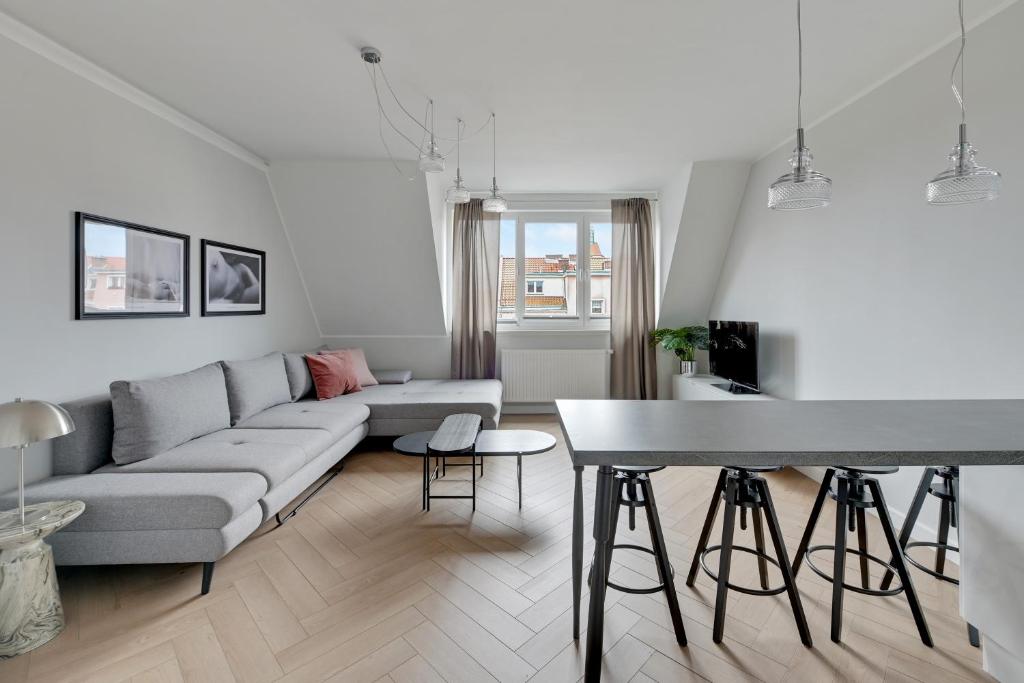 a living room with a couch and a table at Downtown Apartments City Center Tartaczna in Gdańsk