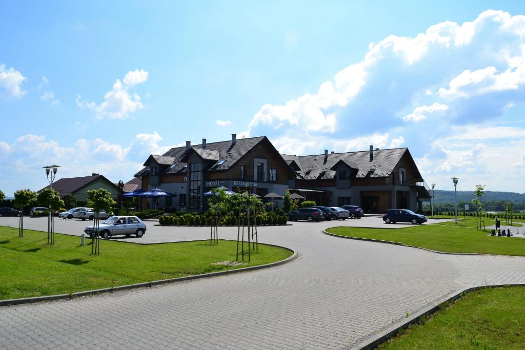 a winding road in front of a house at Hotel Oriza in Gdów