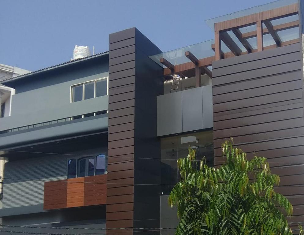 a black building with a tree in front of it at Kunwar Palace in Gorakhpur