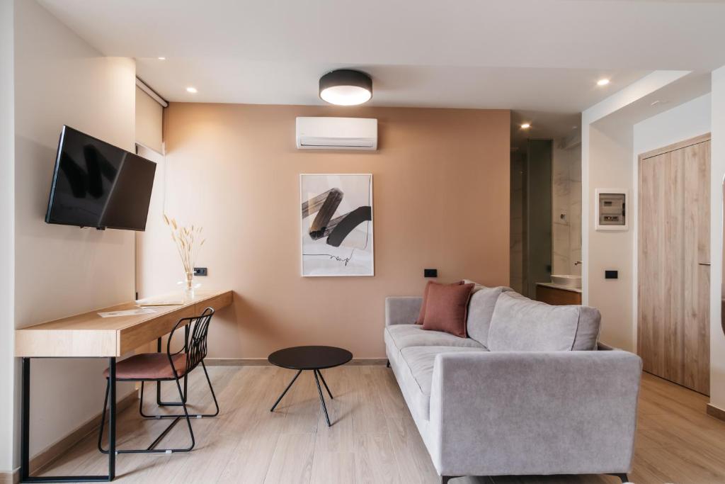 sala de estar con sofá y mesa en The City Hotel & Suites en Rethymno Town