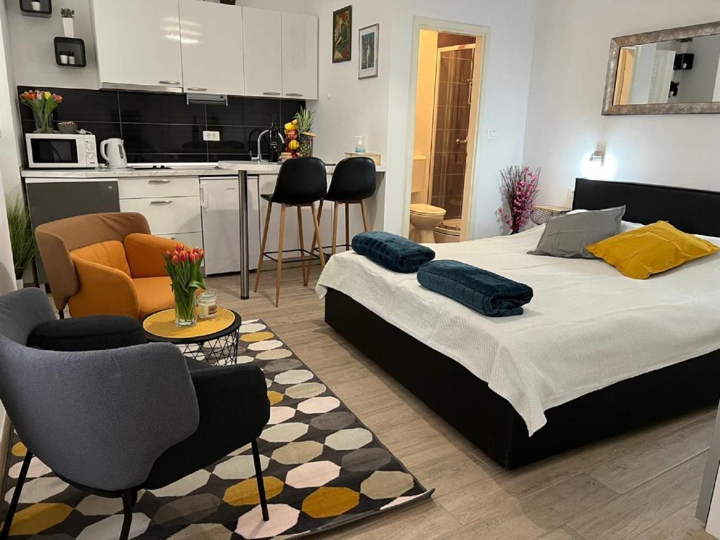 a bedroom with a large bed and a kitchen at Apartments Noa Old Town in Dubrovnik