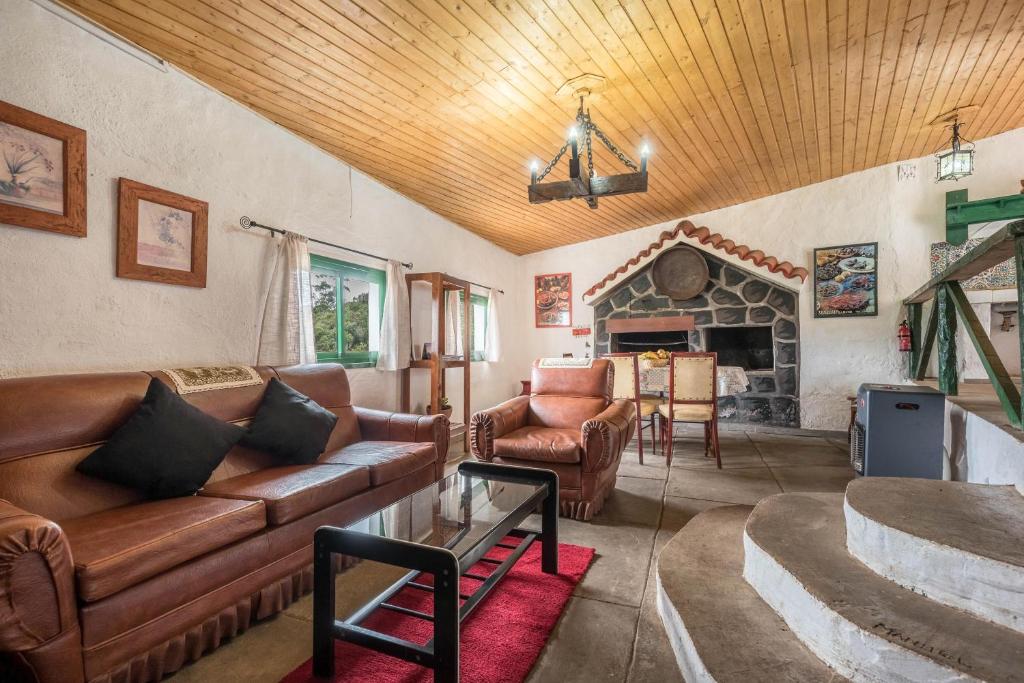 a living room with a couch and a fireplace at Casa rural Teno Alto in Buenavista del Norte
