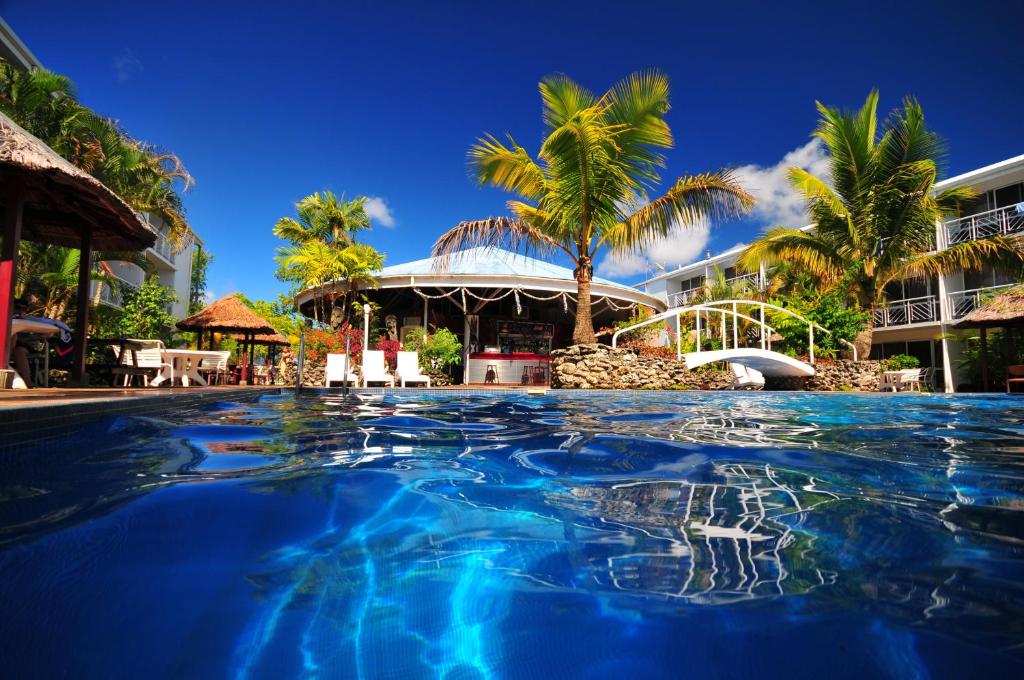 a swimming pool in front of a resort at The Melanesian Port Vila in Port Vila