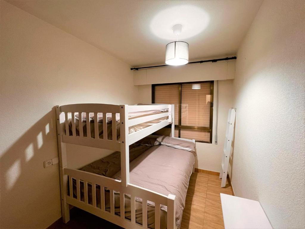 A bed or beds in a room at Marinasunbeach Paseo Maritimo