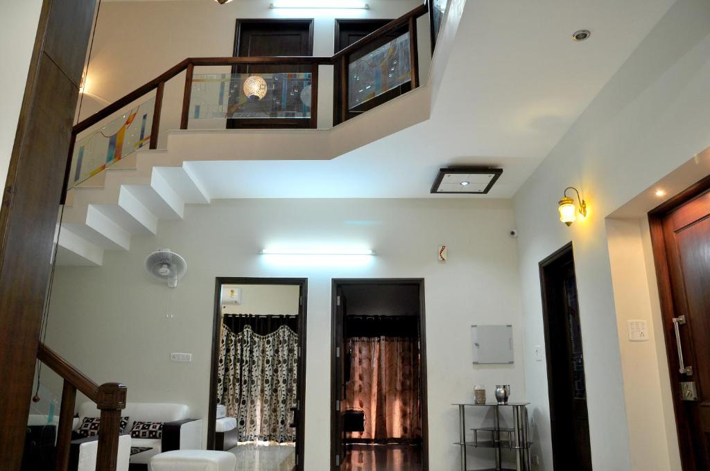 a living room with a staircase and a stair case at Mohini Home Stay in Agra