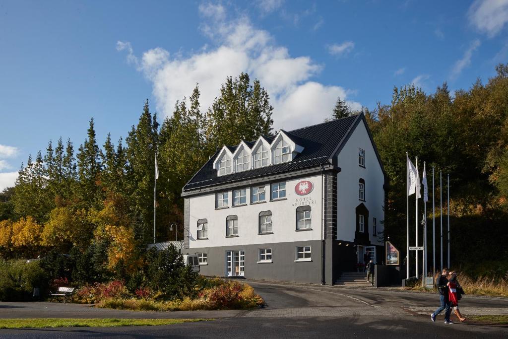 a large building with a clock on the front of it at Hotel Akureyri in Akureyri
