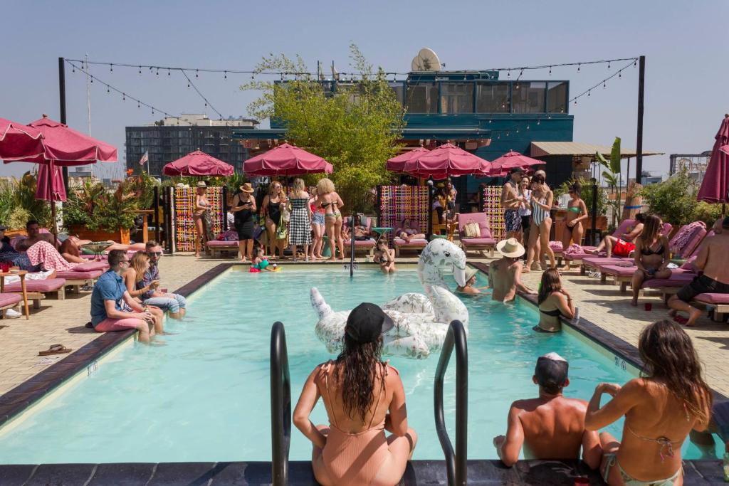 a group of people sitting in a swimming pool at Freehand Los Angeles in Los Angeles
