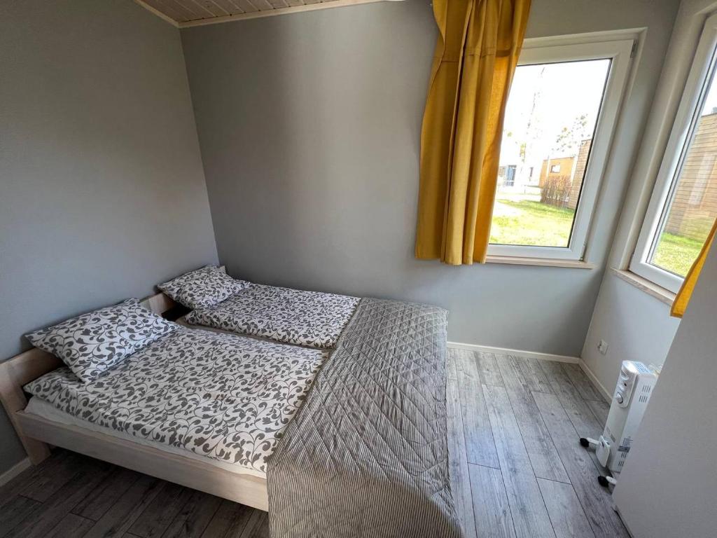 a bed in a room with a window at Sopot 34 przy plaży in Sopot