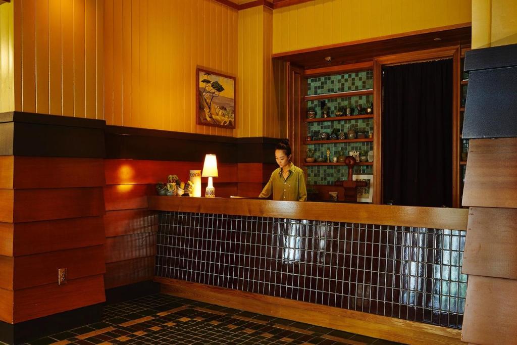 a woman standing behind a bar in a restaurant at Freehand Los Angeles in Los Angeles