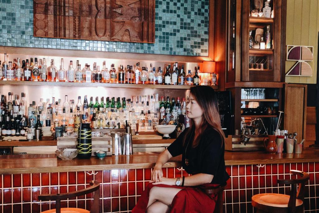 a woman sitting at a bar at Freehand Los Angeles in Los Angeles