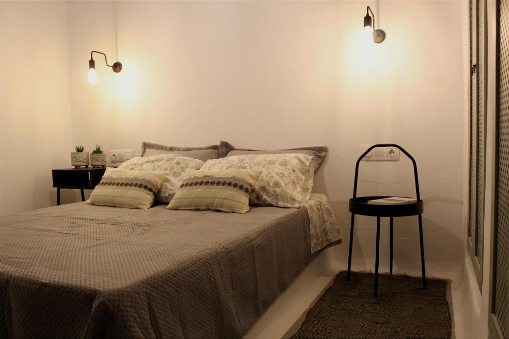 a bedroom with a bed with two pillows on it at Το σπίτι της Γιαγιάς - Granny's guest's house in Kóronos