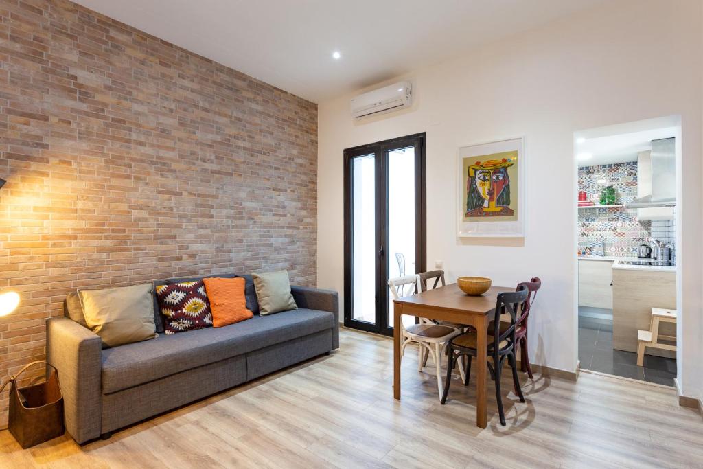 a living room with a couch and a table at Stay U-nique Apartments Travessera II in Barcelona