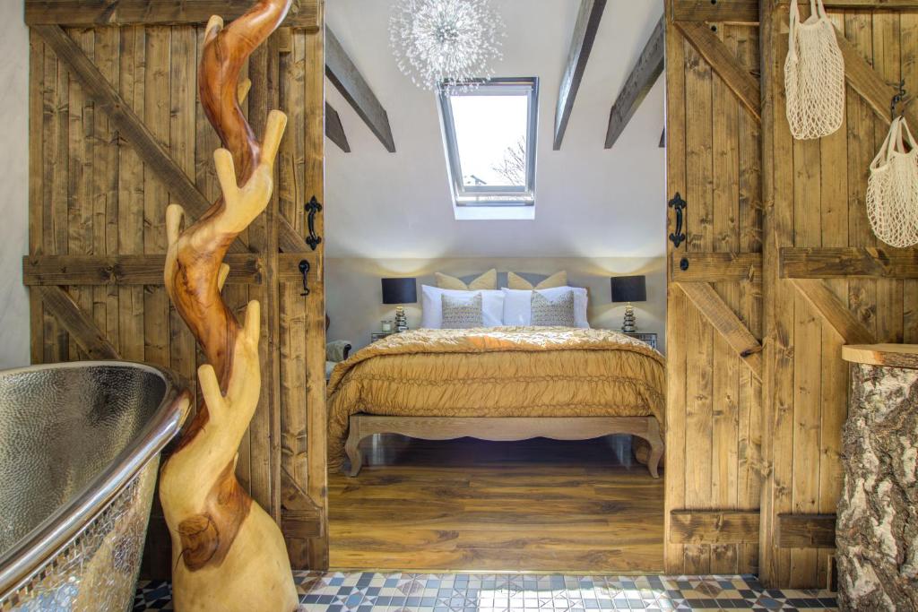 a bedroom with a bed with wooden walls at Unique Cottage The Old Stables Pembrokeshire Sleeps 8 - Welsh Tourist Board Award 5 Stars in Pembroke