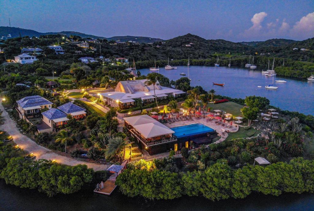 an aerial view of a resort on the water at night at Gunpowder House & Suites in English Harbour Town