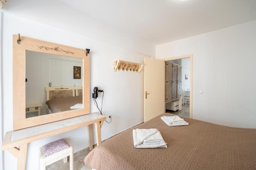 a bedroom with a large mirror and a bed at Villa Giorgos in Kefalos
