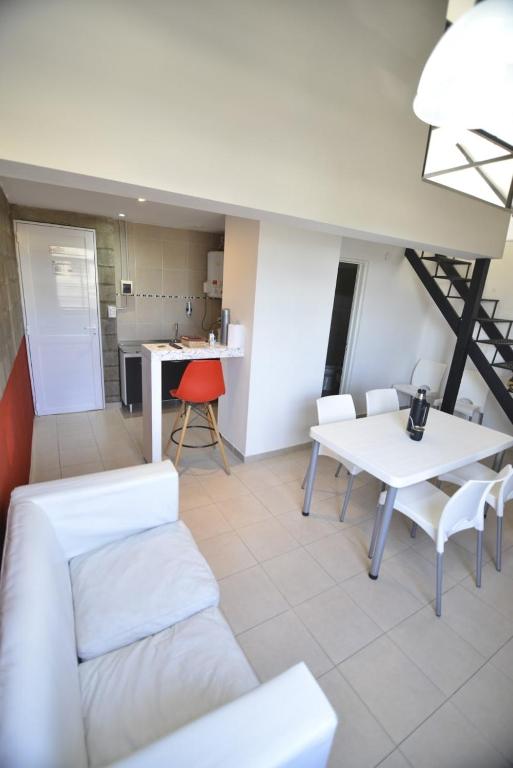 a living room with a white table and chairs at LAS MARAS SUITES in Viedma