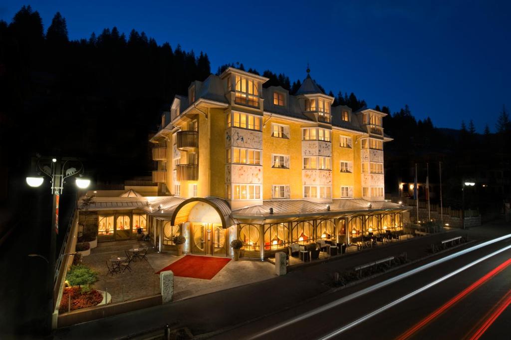 a large building at night with its lights on at Alpen Suite Hotel in Madonna di Campiglio