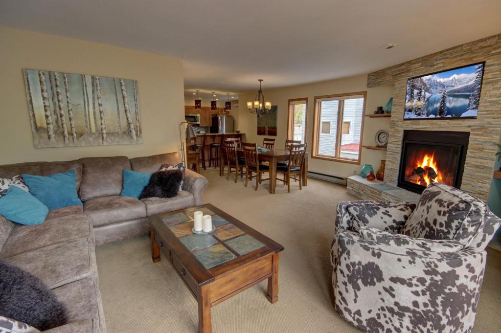 a living room with a couch and a fireplace at Ski Run 201 in Keystone